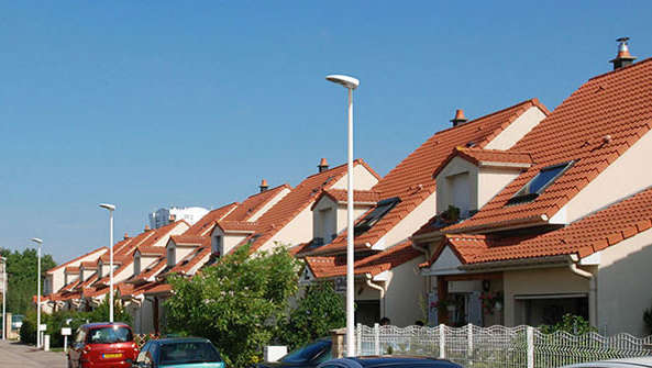 Une rue en plein jour avec luminaires sur mât 