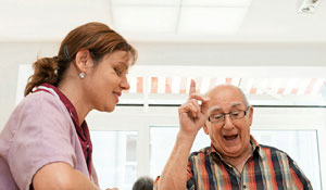 Nurse and patient in an elderly care home which supports natural biorhythms with Philips lighting