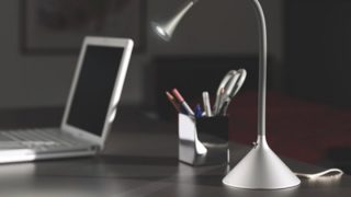 Eine Schreibtischlampe und ein Laptop auf dem Schreibtisch